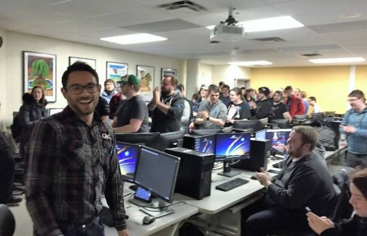 Students standing in classroom with PCs