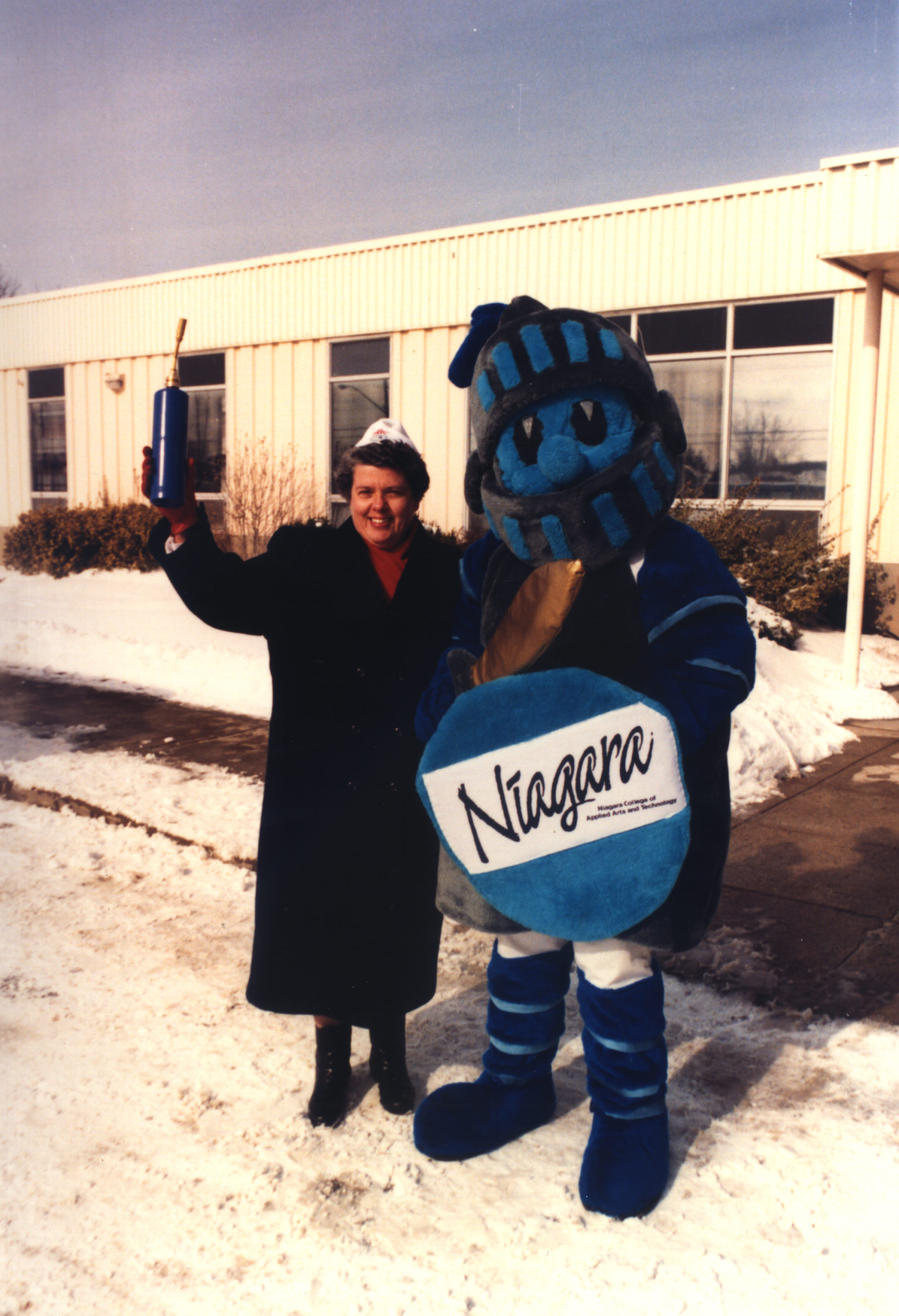 A file photo from 1987 shows former NC president Jaqueline Robarts standing with the NC KNight mascot.
