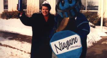 A file photo from 1987 shows former NC president Jaqueline Robarts standing with the NC KNight mascot.