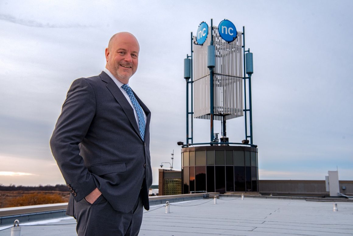 Sean Kennedy is pictured at the Daniel J. Patterson Campus with the NC sign in the background