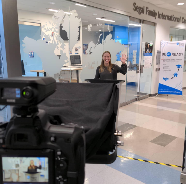 Shawna Luey, NC's former associate director of International Student Services, films part of the International Student Awards virtual ceremony. She is pictured in front of the camera at the Segal Family International Centre.