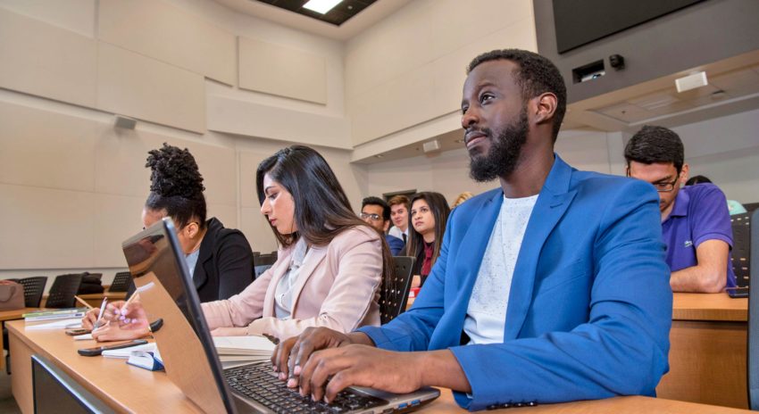 Student attending class in auditorium